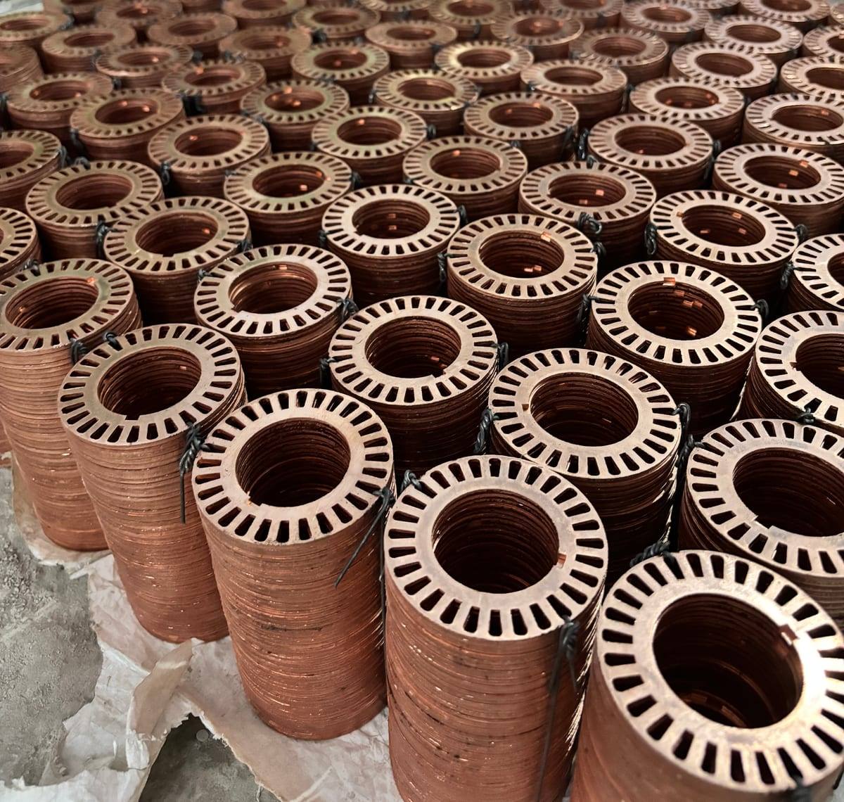 Stacks of slotted copper end rings tied in bundles